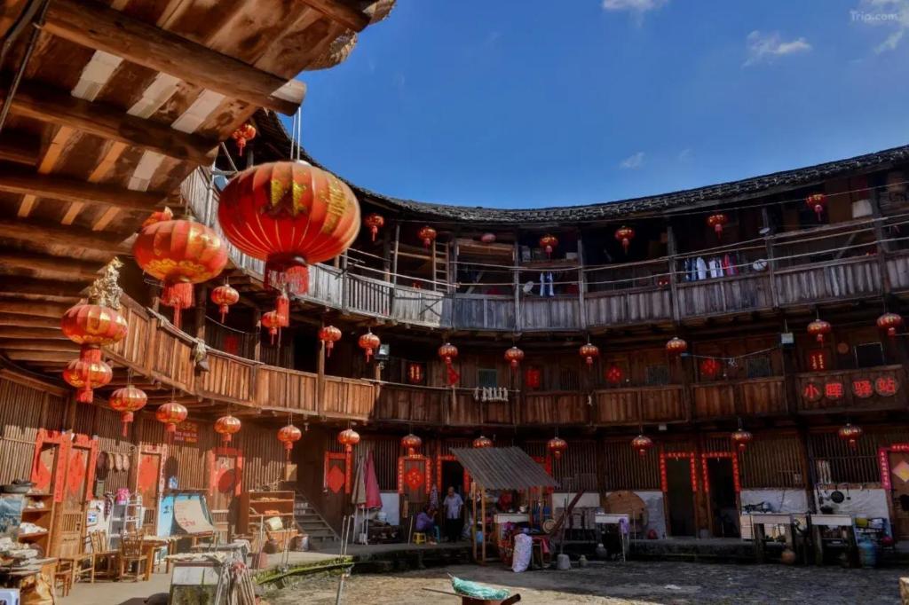 a large building with red lanterns hanging from it at Tsingpu Tulou Retreat 青普文化行馆 南靖土楼店 in Futian