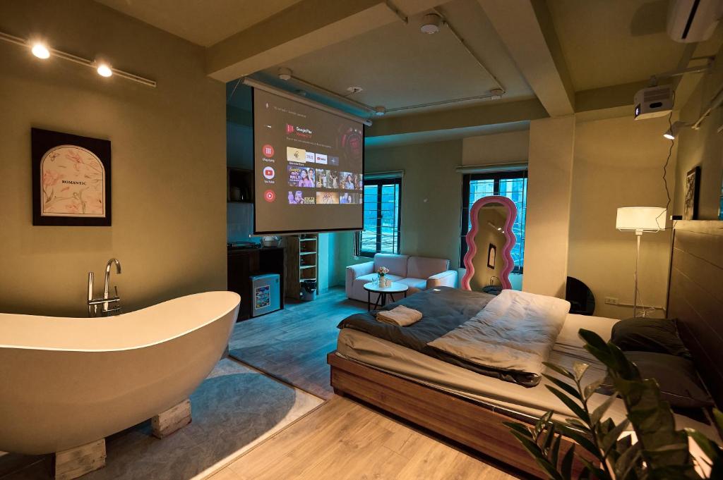 a bathroom with a tub and a bed and a tv at Trên Mây HST - 91 Cầu Diễn in Văn Trì