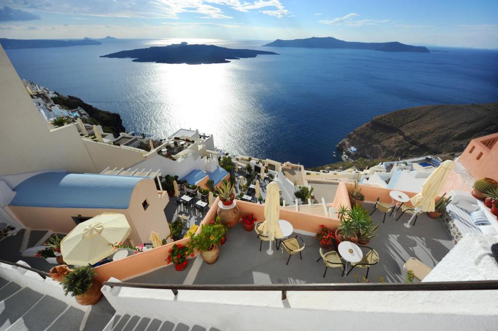 a view of the ocean from the balcony of a resort at Kavalari Hotel - Adults Only in Fira
