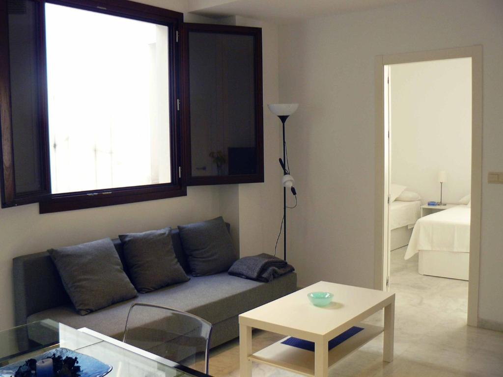 a living room with a couch and a table at Alfaqueque Apartment in Seville