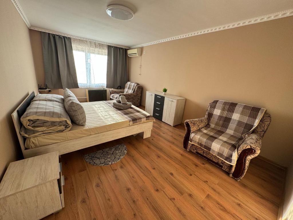 een slaapkamer met een bed en een stoel bij Panorama Spa Apartment in Berehove