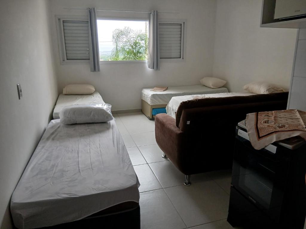 En eller flere senge i et værelse på Condomínio da Fe Canção Nova