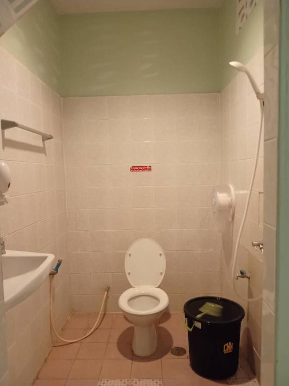 a bathroom with a toilet and a sink at D Love Gueshouse in Ranong