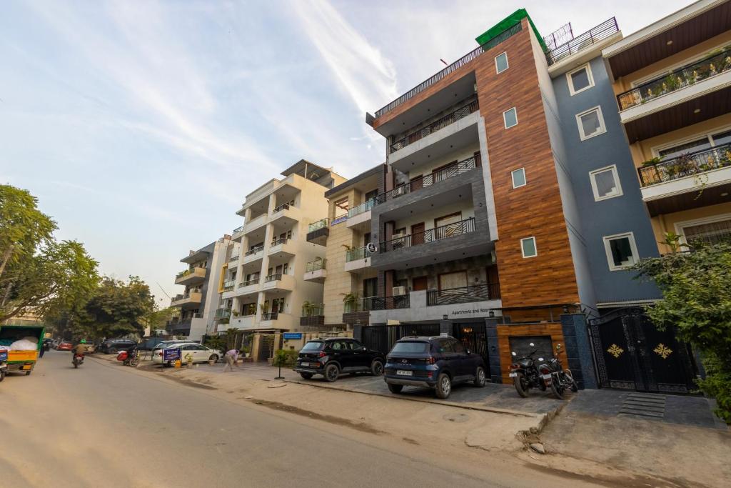 a building on a street with cars parked in front of it at Bnb Sakura , Golf Course Road in Gurgaon