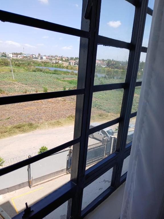 a view out of a window of a bus at Beijing Nest in Syokimau