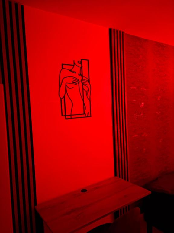 a room with a red wall with a bench in it at Panorama Premium Plac Jana z Głogowa 2 in Głogów