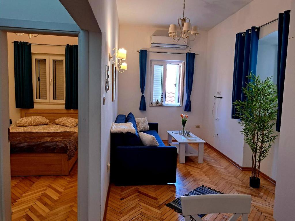 a living room with a couch and a bed at Old town nest in Budva