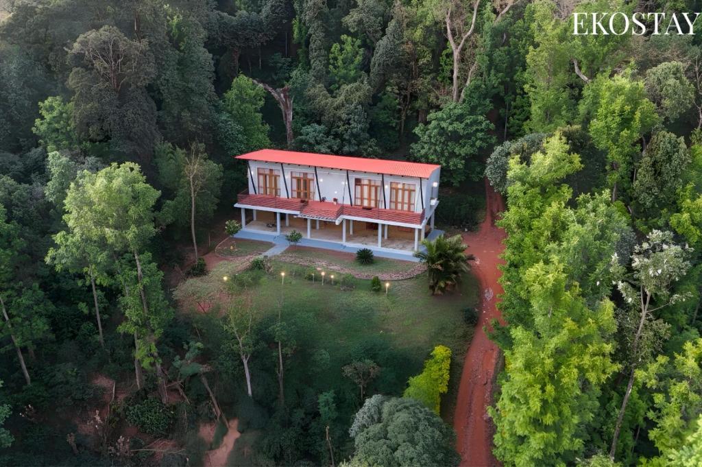 an aerial view of a house in the forest at EKOSTAY - Forest Cube Villa in Attigundi