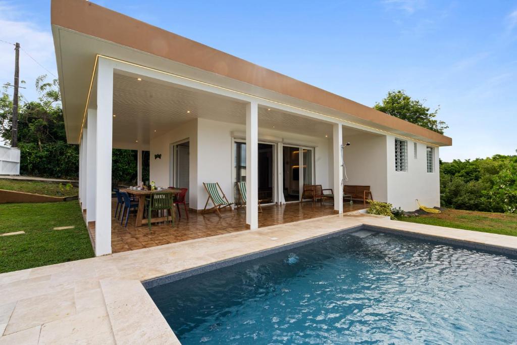 a swimming pool in front of a house at Villa Calaïa in Tartane