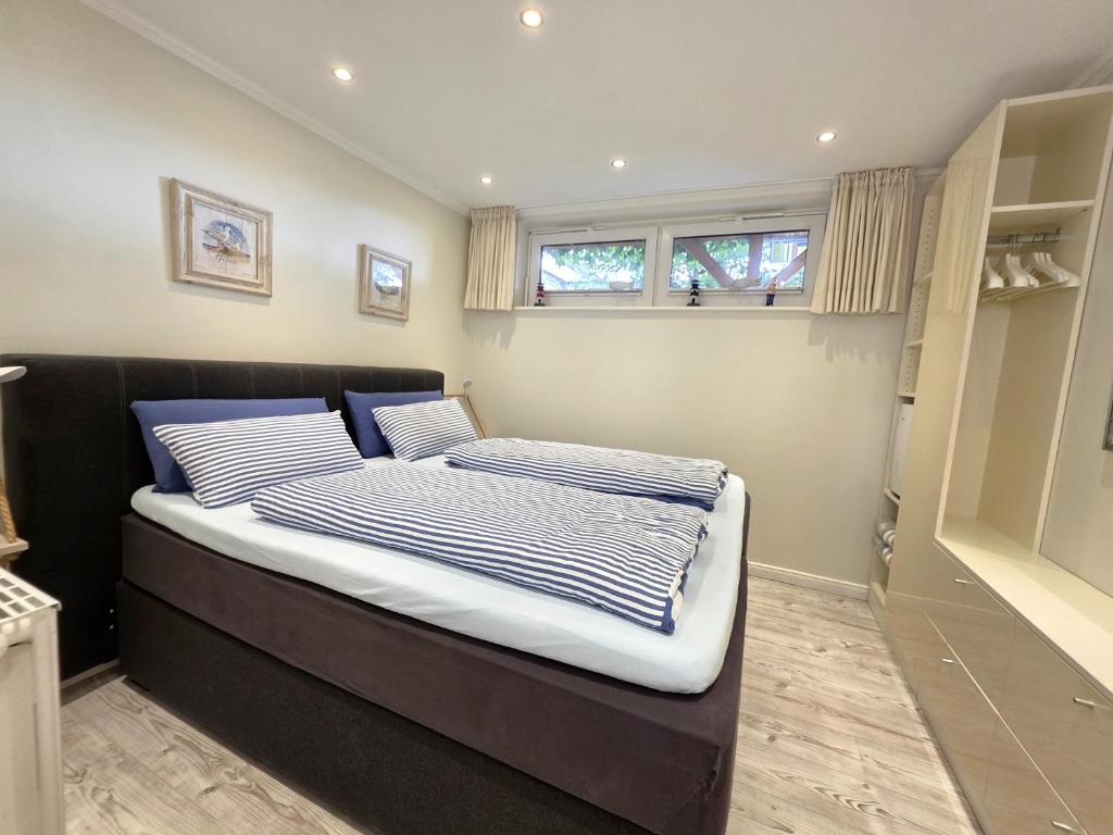a bedroom with a bed with blue and white sheets at Ferienwohnung Smutje in Kiel