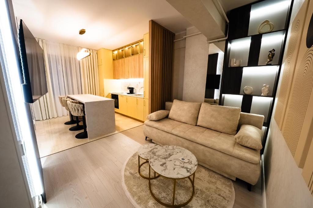 a living room with a couch and a table at Royal Luxury Suite in Iaşi