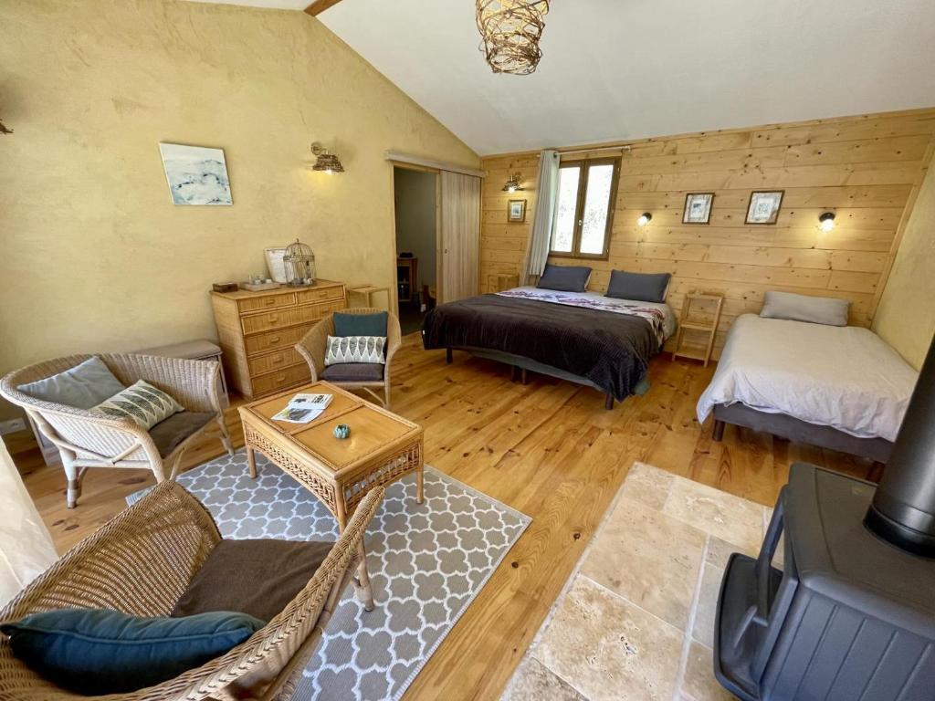 a living room with two beds and a couch at Source Nature in Le Mas-dʼAzil