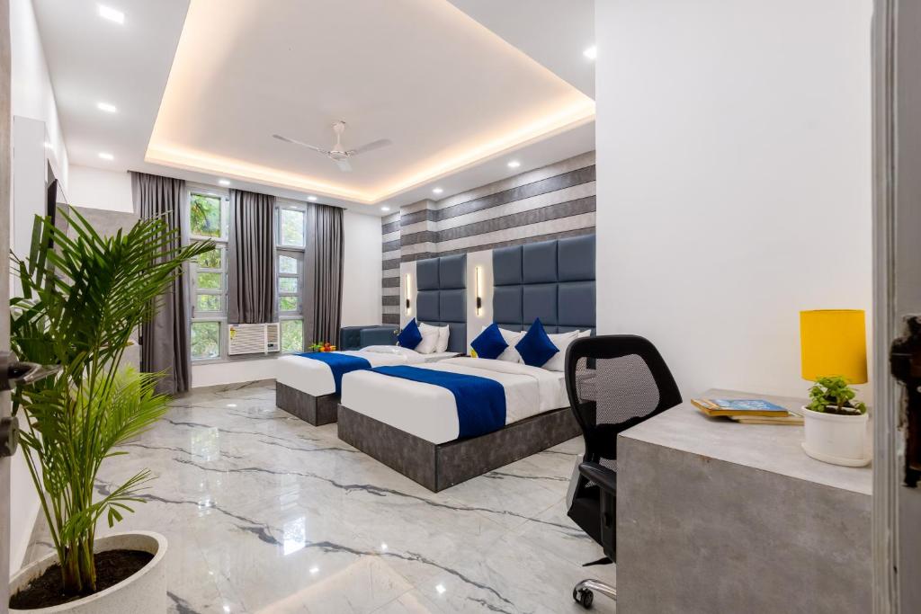 a hotel room with a bed and a desk at Hotel MSRegency At Karol Bagh in New Delhi