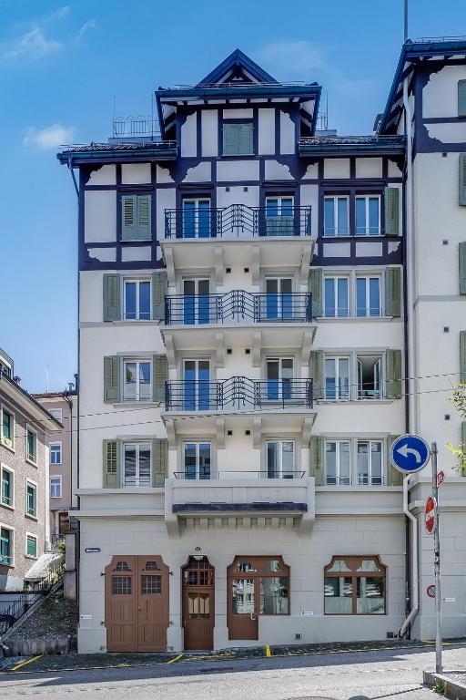 an apartment building with a black and white building at Urban Hideaway Studio St Gallen Center Self Check-In in St. Gallen