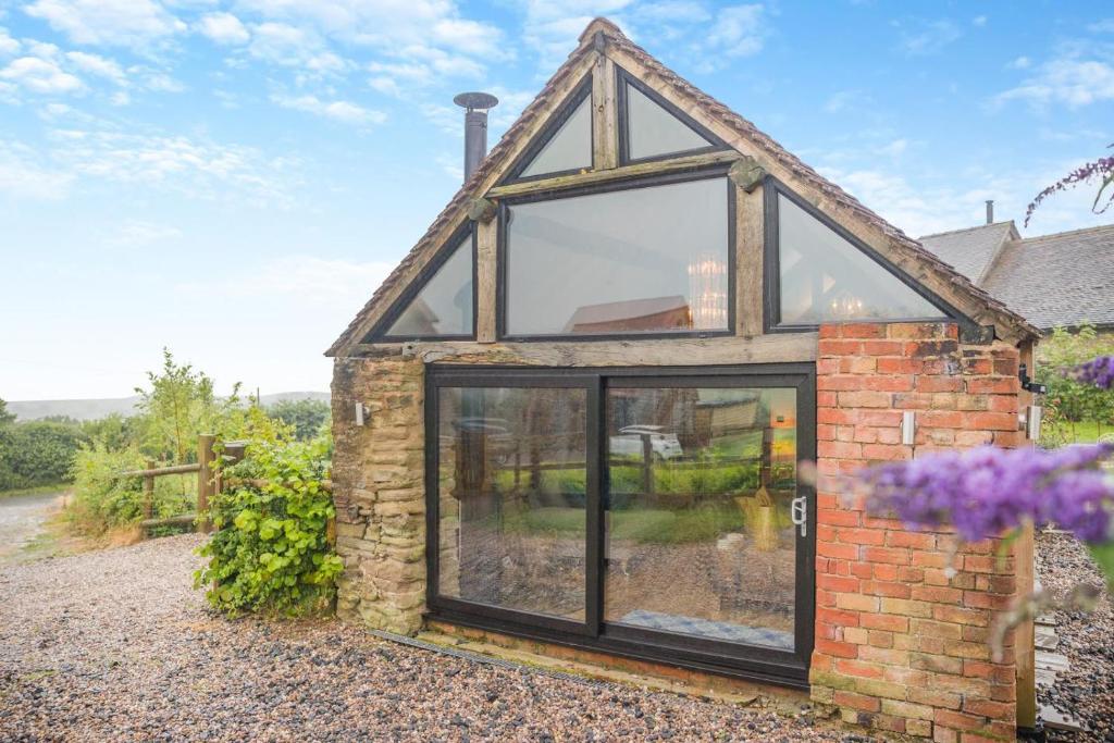 a brick house with large glass windows at 1 Bed in Wheathill oc-t29765 in Loughton