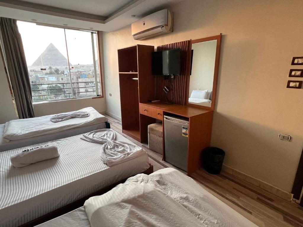 En eller flere senge i et værelse på First pyramids view inn