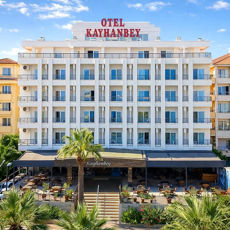 ein Hotel mit einer Palme davor in der Unterkunft Kayhanbey Hotel in Kusadası