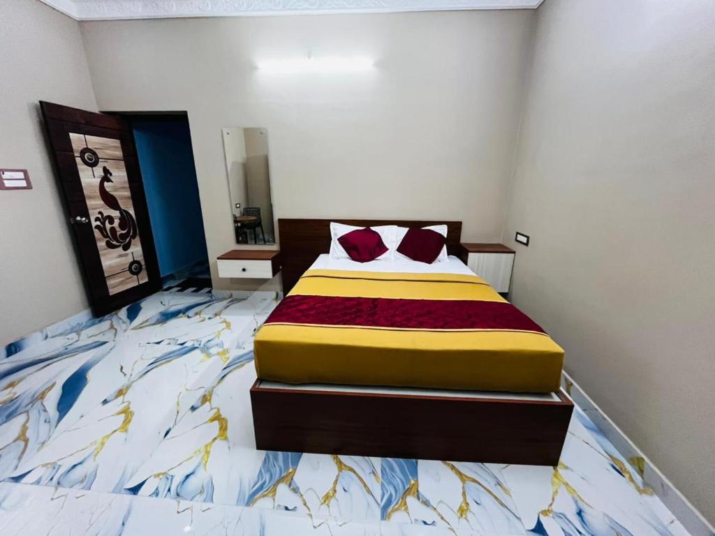 a bedroom with a bed with a colorful bedspread at Villa D Amour in Pondicherry