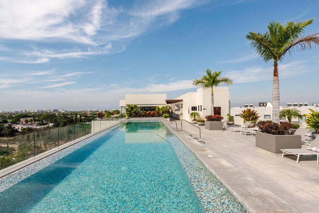 a swimming pool on the roof of a house at Luxury Condo en Nuevo Vallarta Alberca Tipo Resort in Nuevo Vallarta