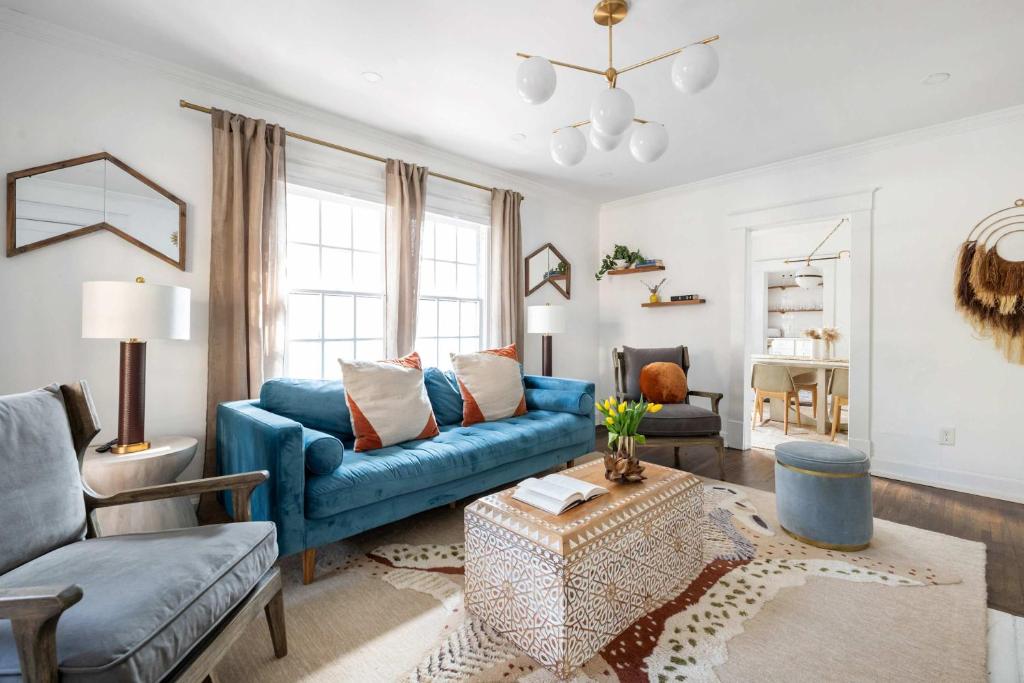 a living room with a blue couch and a table at Golden Gazelle in Atlanta