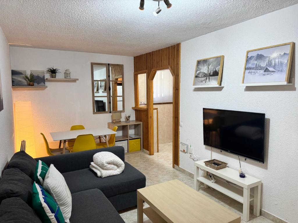 a living room with a couch and a flat screen tv at PROBER_NEVADA II in Pas de la Casa