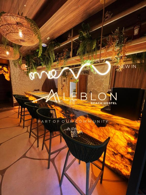 a restaurant with chairs and a bar with the words welcome to the salon at Leblon Beach Hostel in Rio de Janeiro