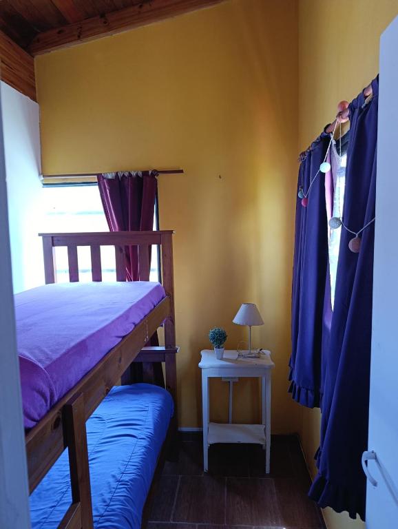 a bedroom with a bunk bed and a side table at Monoambiente in Mar de Ajó