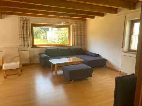 a living room with a couch and a table at Ferienhaus Wolfurt in Wolfurt