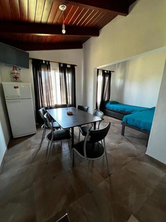 a room with a table and chairs and a bed at La Soñada in Miramar