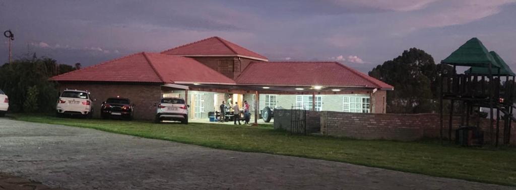 a house with two cars parked in front of it at Riverside Inn in Oranjeville