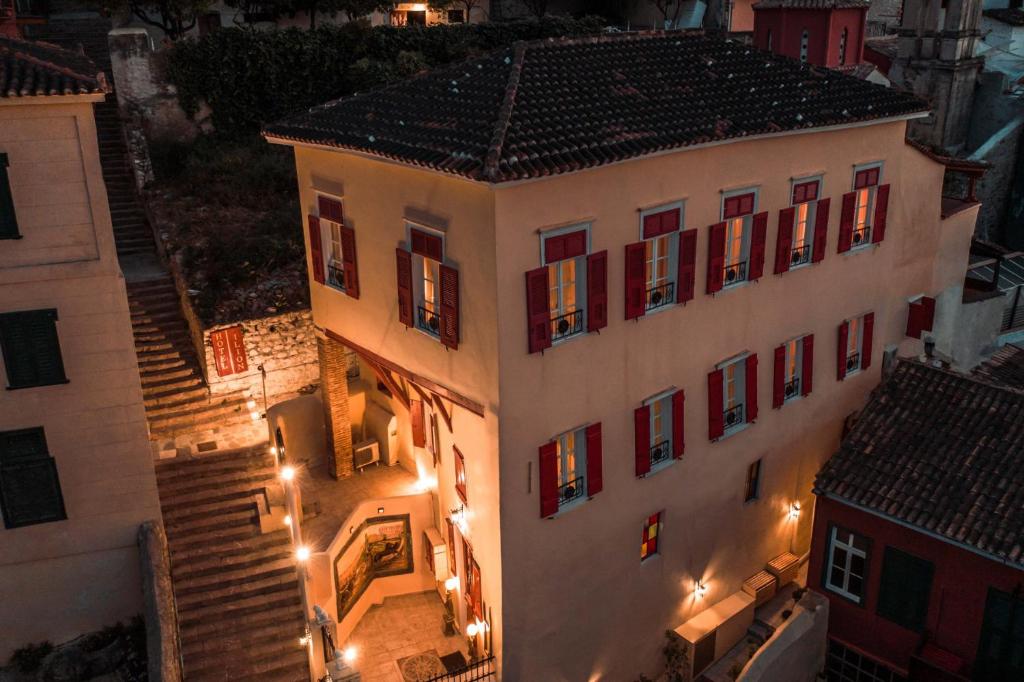 an overhead view of a building with red windows and stairs at Ilion Hotel in Nafplio