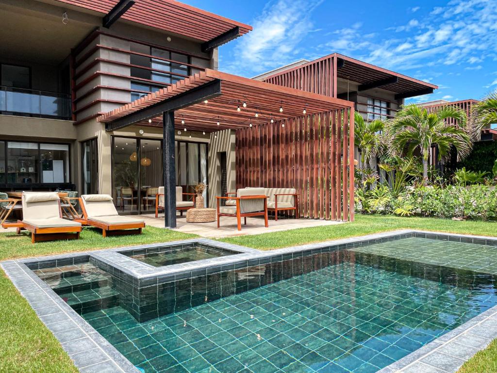 a backyard with a swimming pool and a house at The house - Casa Coral in Trairi