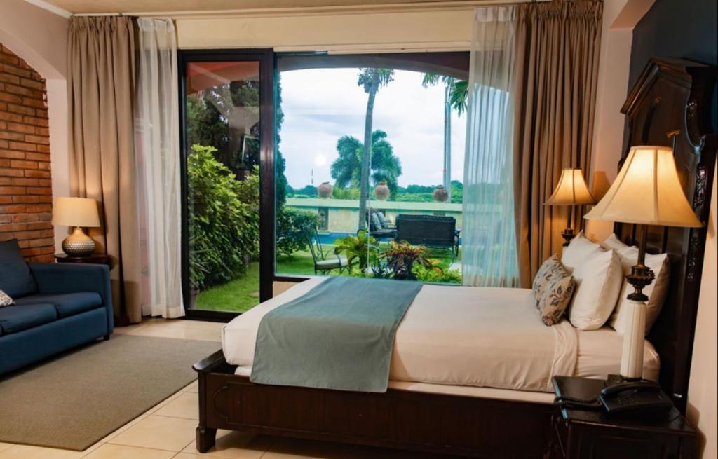 En eller flere senge i et værelse på Altos de Fontana by Macondo Collection