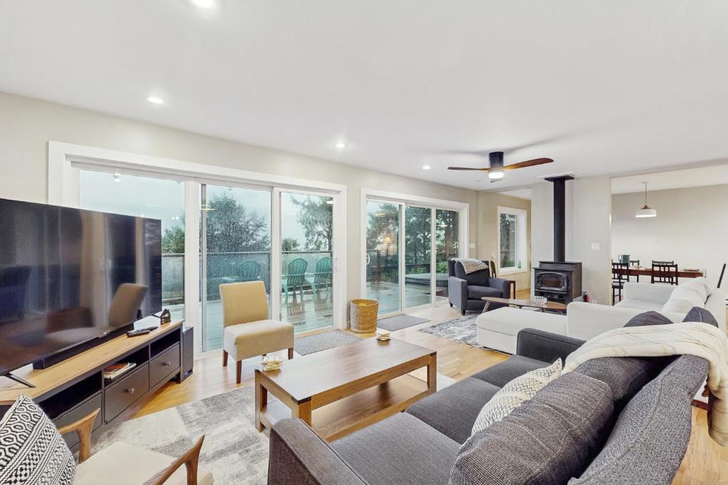 a living room with a large flat screen tv at Saltwind Shores in Moclips