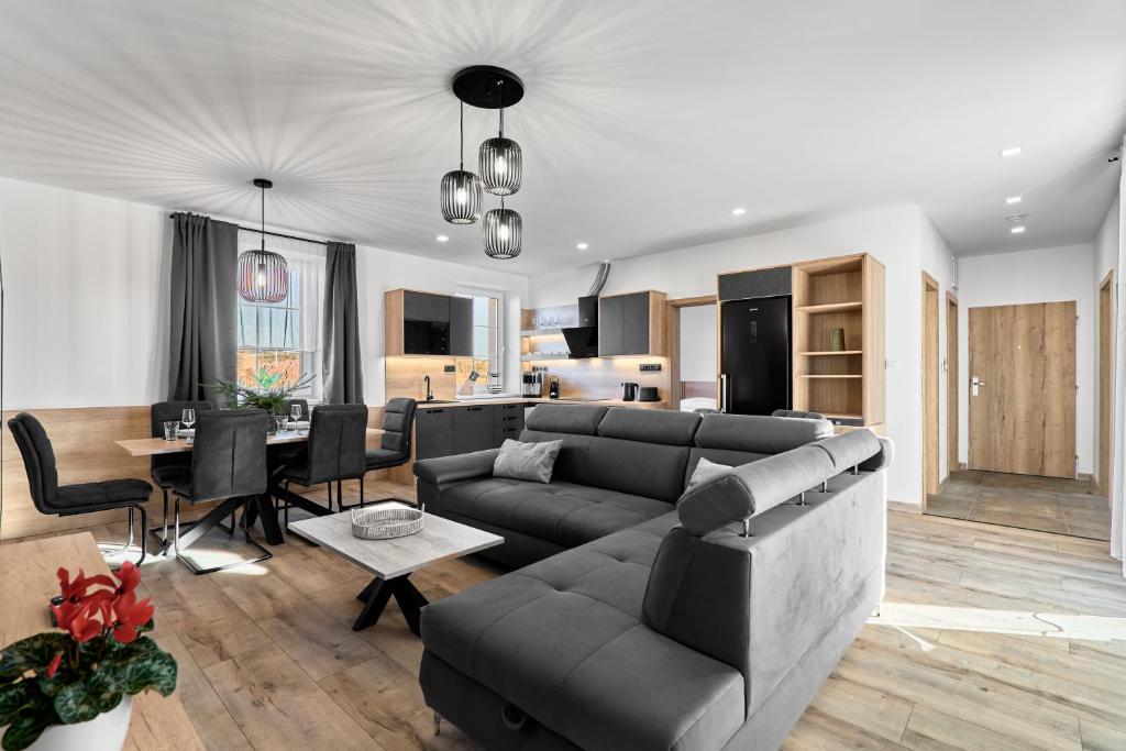 a living room with a couch and a table at Rezidence George by Mountain ways in Kovářská