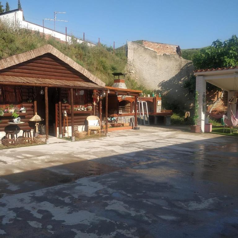 a building with a shop with a mountain in the background at Ramon del Xalet in Ibars de Noguera