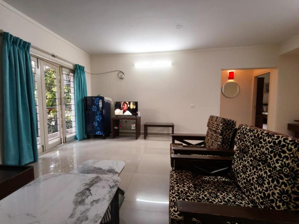 a living room with a couch and a tv at 2bhk furnished Richmond town in Bangalore