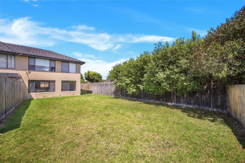 a backyard of a house with a fence at A Beachside Villa with Vogue Verve in Altona