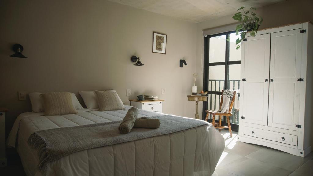 een slaapkamer met een groot bed en een groot raam bij Ambar Posada Boutique in Aiguá