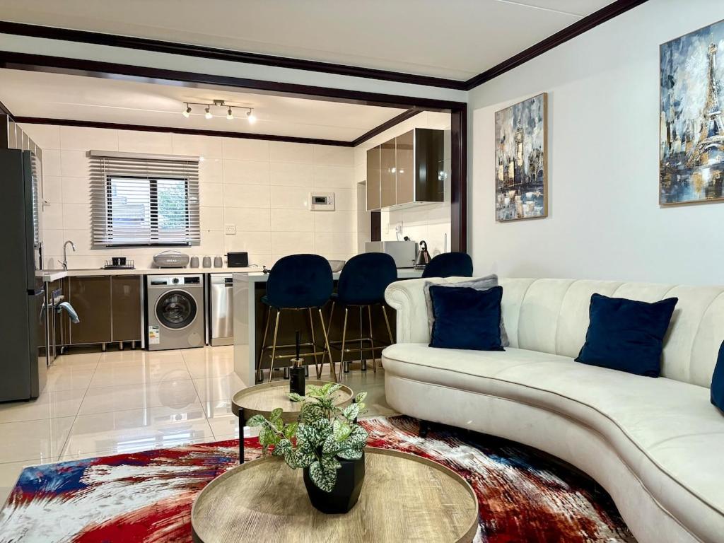 a living room with a couch and a table at The Gentle Nest in Trevallyn