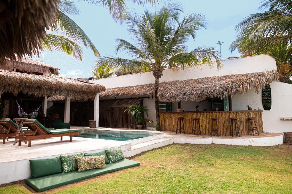 a villa with a swimming pool and a resort at Kitenest in Itarema