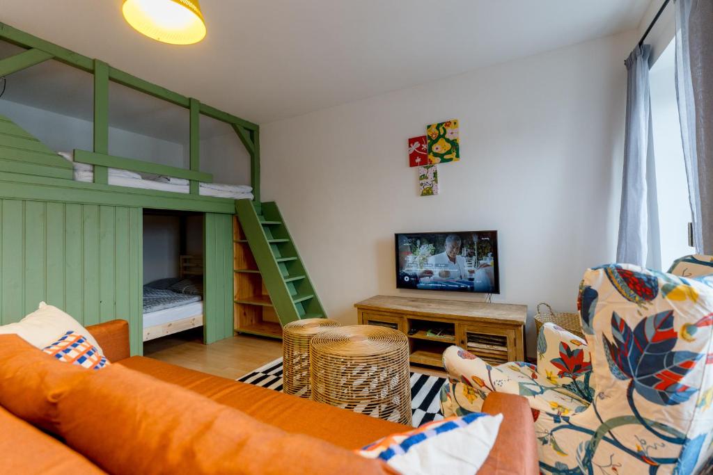 a living room with a couch and a bunk bed at Boží Dar 95 in Boží Dar