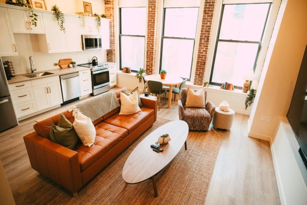 a living room with a couch and a table at Historic Charming 2BR Apartment DT Halifax in Halifax