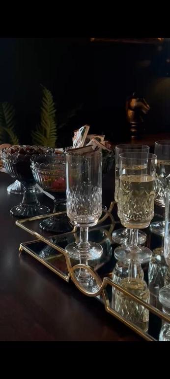 a tray with glasses and a bowl of water on a table at Gustavsbo in Ljungbyhed