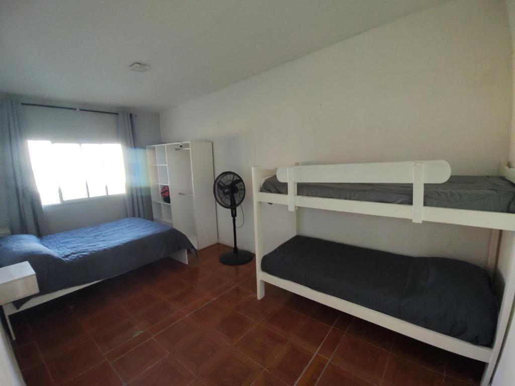een kamer met 2 stapelbedden en een ventilator bij El descanso in Necochea