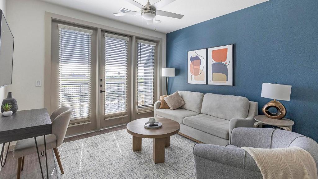 a living room with a couch and a table at Landing Apartments - The Quinn in Anna