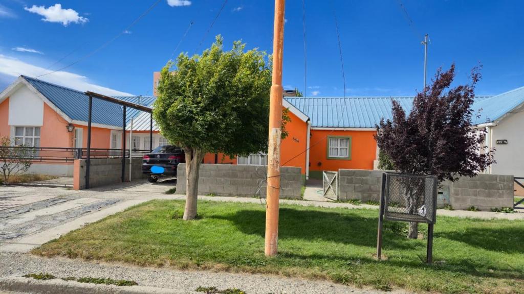 Ein Baum und ein Straßenschild vor einem Haus in der Unterkunft Valle del Río Chico in Gobernador Gregores