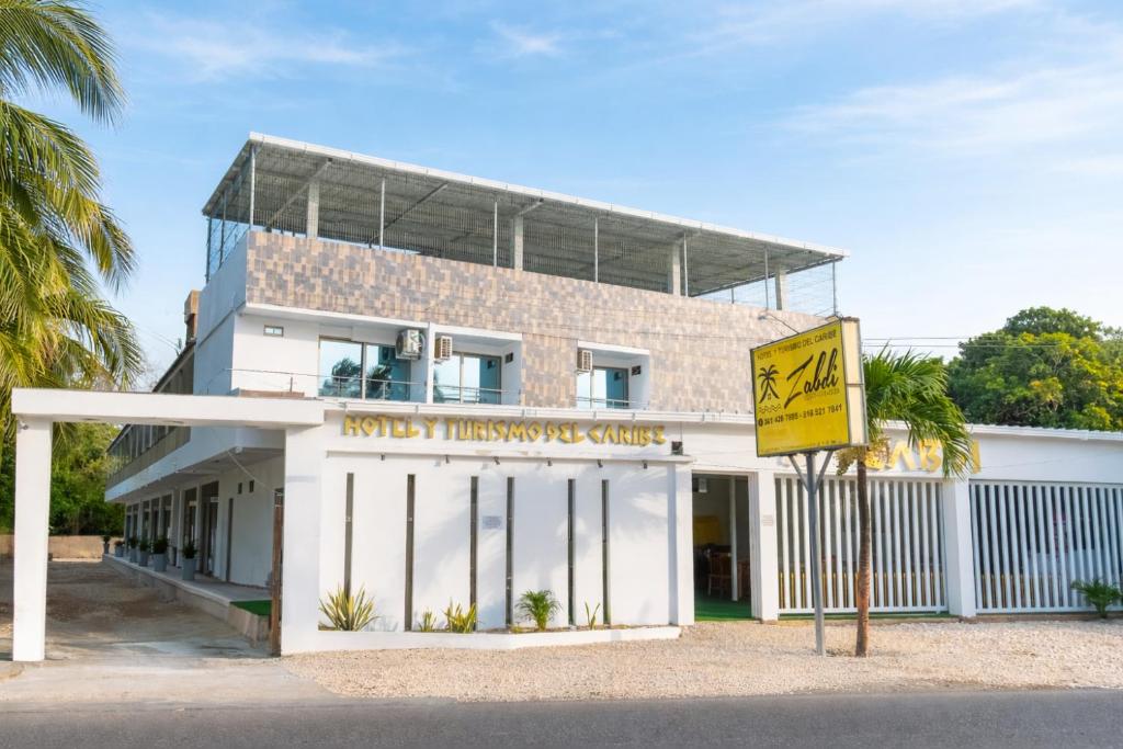a building with a sign in front of it at ZABDI COVEÑAS in Coveñas