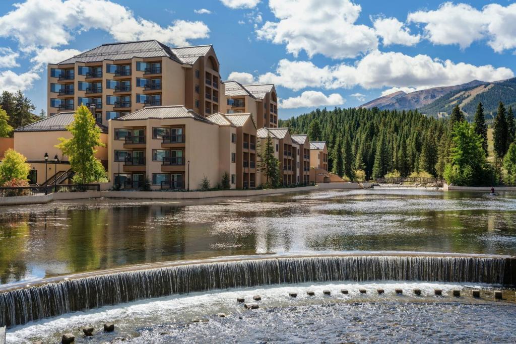 a hotel with a waterfall in front of a river at Marriott's Mountain Valley Lodge at Breckenridge in Breckenridge