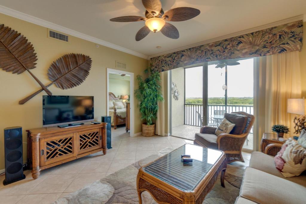 a living room with a couch and a tv at River Strand Country Club Condo with Pool Access! in Bradenton
